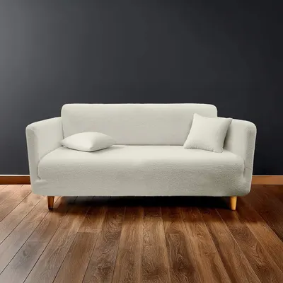 Husă crem elastică pentru canapea cu 3 locuri Laina – douceur d'intérieur